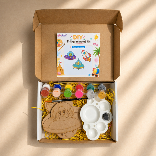 Top View of DIY Space Explorer Fridge Magnet Kit showing 3 MDF Cutouts Paints Brush and Palette laid flat